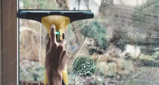 A lady is Cleaning windows