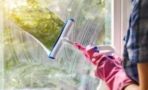 A person is cleaning windoes